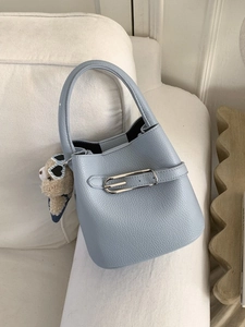Light blue lychee leather bucket bag with silver buckles and a cute plush bear charm