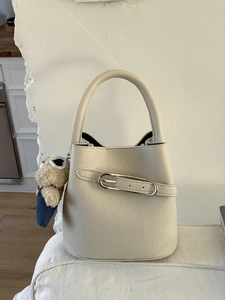 Elegant cream leather bucket handbag with silver buckle and cute blue bear plush charm
