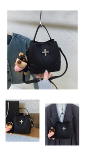 Chic black litchi grain bucket bag styled with a cute puppy charm and silver hardware