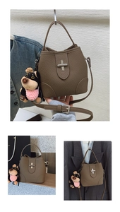 Detailed view of a brown pebbled leather bucket bag featuring a cute dog charm accessory