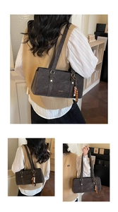 Detail of dark brown leather Boston bag with beaded tassel and gold ZHCNMA logo