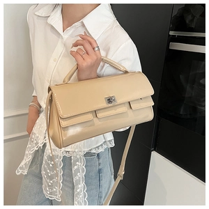 Close-up of milk tea faux leather flap handbag with silver metal knob and top handle