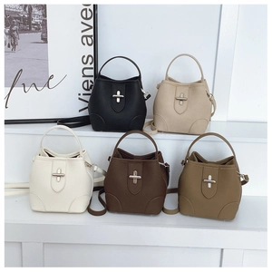 Detailed close-up of textured bucket bags in five colors with cross-shaped metal locks