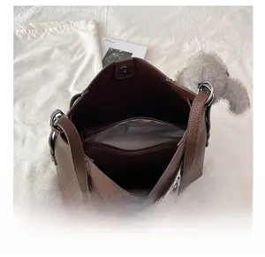 Detailed interior of brown pebbled leather tote with spacious main pocket and zipper pocket