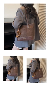 Detail of dark brown suede tote bag featuring a wooden bead charm and brand logo