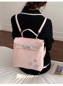 Pink wrinkled leather backpack with silver bow decoration and metallic star details