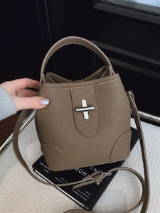 Chic tan litchi pattern bucket bag with silver twist lock and adjustable strap