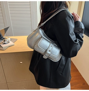 Detail of silver vintage cracked texture PU shoulder bag with buckle pocket on model