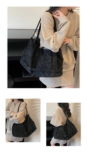 Detail of black large-capacity tote bag featuring industrial texture and silver hardware