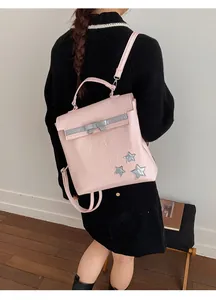 Pink pleated leather backpack with star patches and bow detail shown on a model