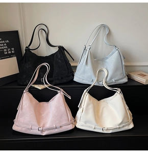 Detail view of large tote bags in four colors with decorative buckle and shoulder straps