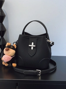 Minimalist black pebble leather bucket bag with silver clasp and cute puppy charm