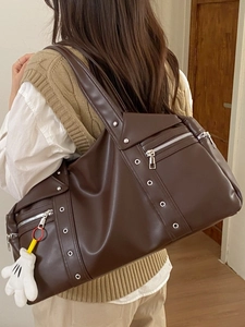 Brown vintage motorcycle style hobo bag with silver hardware and cartoon glove pendant