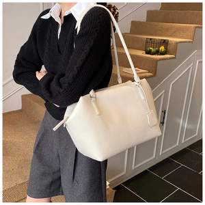 Detail of off-white lychee grain leather tote bag with long shoulder strap and large capacity