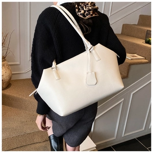 Minimalist white lychee texture tote bag shown on a model in a modern interior setting