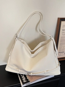 Creamy PU leather tote bag with multi-belt buckle details and adjustable shoulder strap