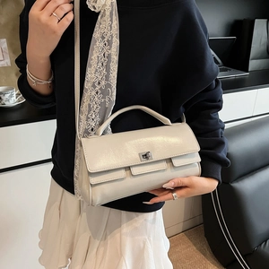Minimalist beige flap handbag with silver twist lock and detachable crossbody strap