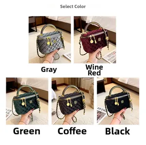 Detail view of velvet quilted crossbody bags in five colors with gold hardware