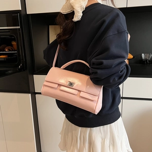 Minimalist light pink patent leather flap bag with silver turn-lock and shoulder strap
