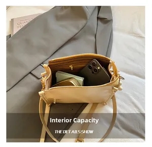Detail view of large beige commuter bag showing internal capacity and striped lining