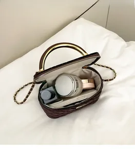 Detailed interior of dark brown velvet quilted bag showing spacious storage and chain strap