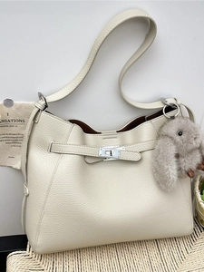 Elegant off-white pebbled leather bucket bag with silver twist lock and bunny charm