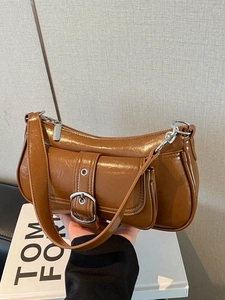 Chic caramel brown glossy faux leather underarm bag with silver buckle and shoulder strap