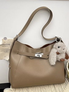 Taupe pebbled leather bucket bag with silver twist lock and plush rabbit pendant charm