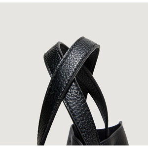 Close-up of black lychee grain leather tote bag handle with double stitching detail