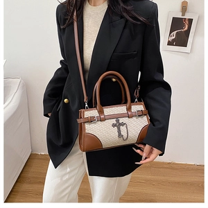 Retro tote bag featuring brown leather and beige weave with a silver cross chain charm