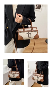 Detail of vintage woven cream handbag with brown trim and bronze cross charm hardware
