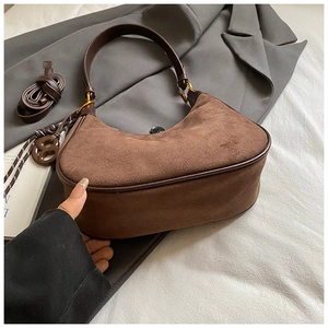 Detail of dark brown matte leather hobo bag with vintage gold hardware and dual straps