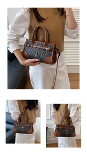 Close-up of contrast weaving handbag with brown leather trim and vintage metal cross charm