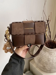 Vintage dark brown woven leather crossbody bag with metal chain and plush charm