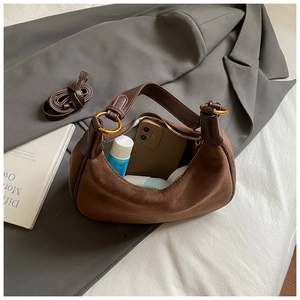 Brown suede hobo bag interior view showing large storage capacity and long strap