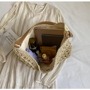 Close-up of spacious woven tote bag interior holding a tablet, umbrella, and cosmetics
