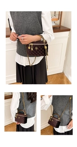 Detail of dark brown velvet quilted handbag with gold handle and chain strap