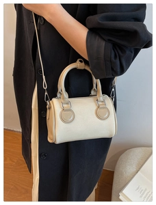 Detail view of mini Boston bag in cream canvas and beige leather with silver hardware