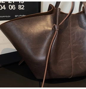 Detail shot of the vintage dark brown faux leather tote with textured grain and ties