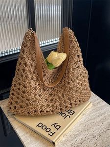 Caramel hand-woven straw tote bag with hollow diamond pattern and leather shoulder straps