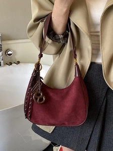 Retro burgundy suede hobo bag with adjustable shoulder strap and leather pendants
