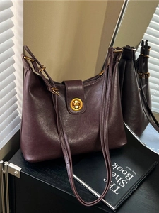 Retro dark brown leather bucket bag with gold twist lock and adjustable shoulder strap