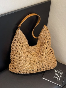 Large woven hollow straw tote bag with brown leather shoulder strap for beach vacation