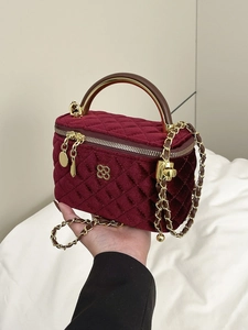 Elegant burgundy velvet quilted crossbody bag with gold clover logo and chain strap