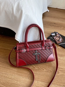 Deep red woven leather handbag with vintage cross charm and metal chain straps