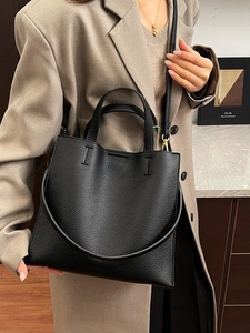 Fashionable black pebbled leather tote bag for women with gold hardware and shoulder strap