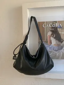 Retro black leather half-moon tote bag with woven knot shoulder strap and large capacity