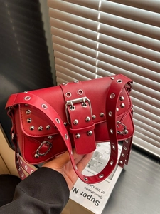 Red punk leather baguette bag with silver rivets and metal hardware in Y2K vintage style