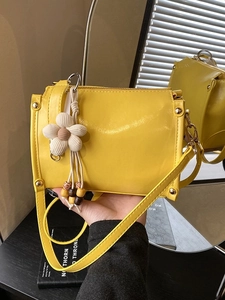 Bright yellow vintage crossbody bag for women with floral charm and rivet details