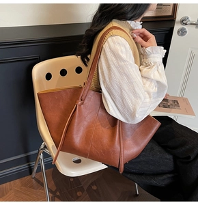 Detail view of large vintage brown tote bag with leather drawstrings for women